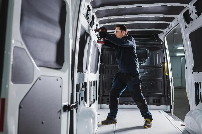 What is involved in setting up the electrical and plumbing systems in a campervan?